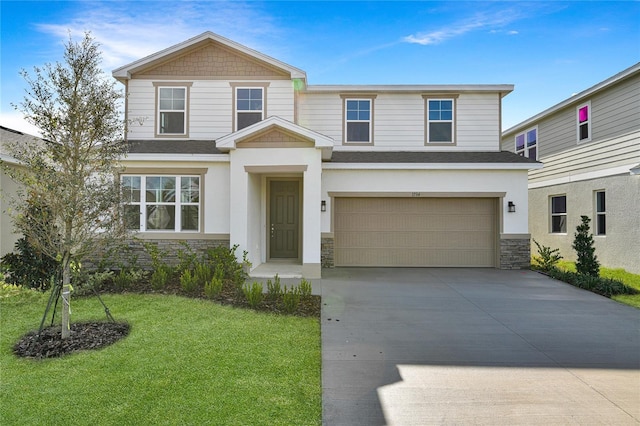 view of front of property featuring a front yard and a garage