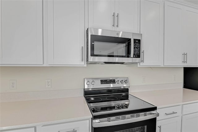 kitchen with appliances with stainless steel finishes and white cabinetry