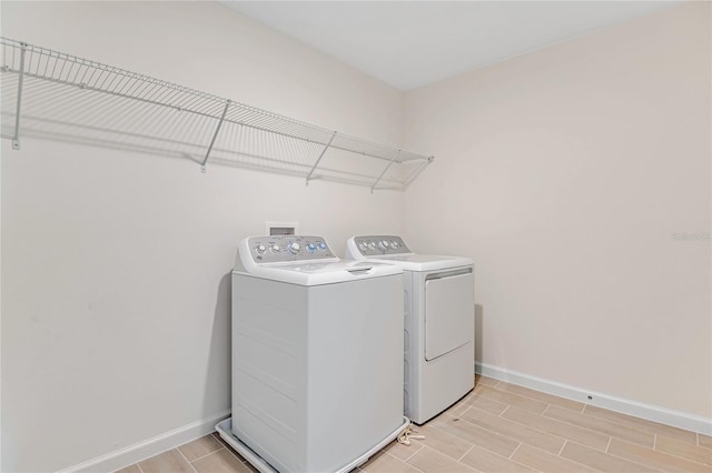 clothes washing area with washer and clothes dryer