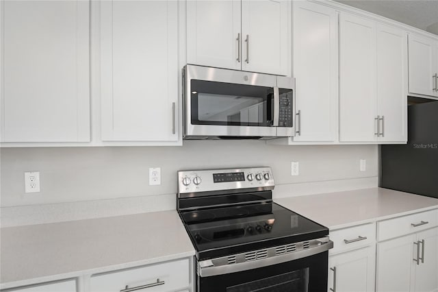 kitchen with appliances with stainless steel finishes and white cabinetry