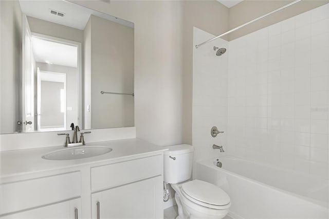 full bathroom with vanity, tiled shower / bath combo, and toilet