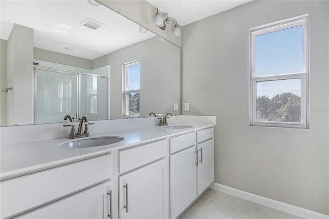 bathroom featuring tile patterned floors, vanity, and walk in shower