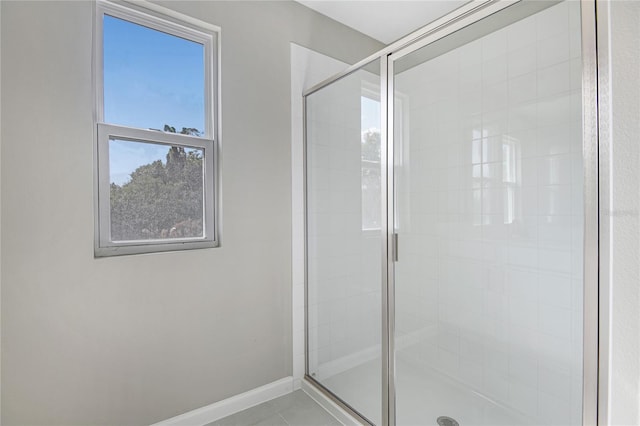 bathroom featuring tile patterned floors and a shower with door