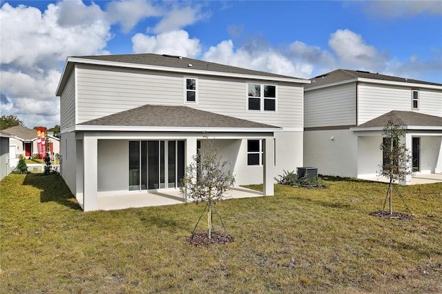 rear view of house featuring a patio area, a yard, and cooling unit