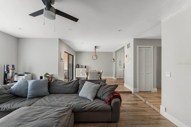 living room featuring ceiling fan and hardwood / wood-style floors