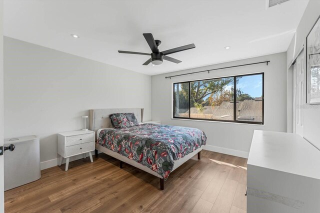 bedroom featuring hardwood / wood-style flooring and ceiling fan