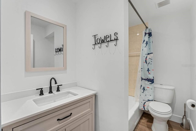 full bathroom with shower / tub combo with curtain, vanity, wood-type flooring, and toilet