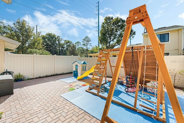 view of playground with a patio area