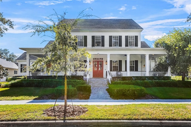 view of front of house with covered porch and a front lawn