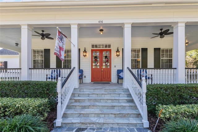 entrance to property with ceiling fan and a porch