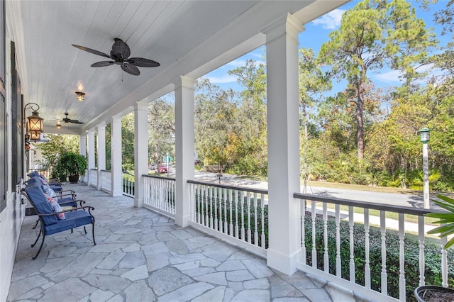 unfurnished sunroom featuring ceiling fan and wood ceiling