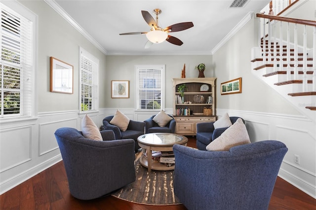 living room featuring dark hardwood / wood-style flooring, ceiling fan, and crown molding