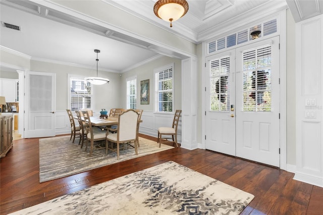 dining space featuring crown molding and dark wood-type flooring