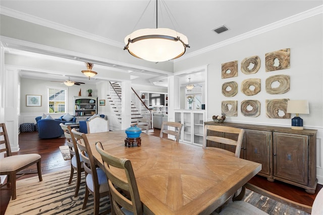 dining space featuring dark hardwood / wood-style flooring and ornamental molding