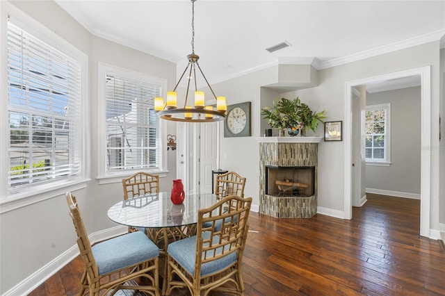 dining space featuring an inviting chandelier, crown molding, and dark wood-type flooring