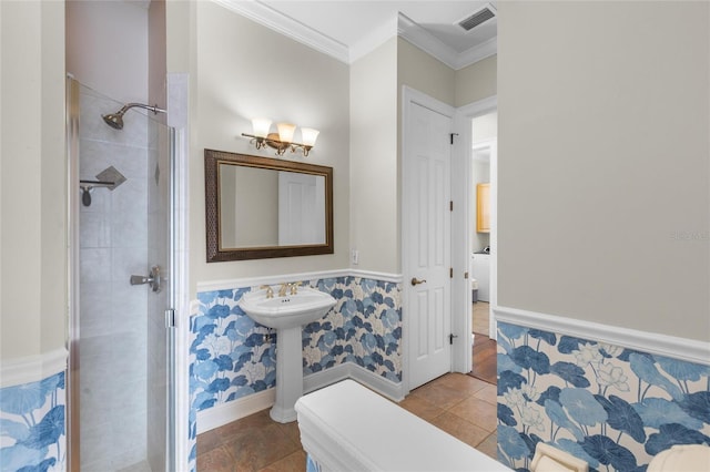 bathroom featuring an enclosed shower, ornamental molding, and tile walls