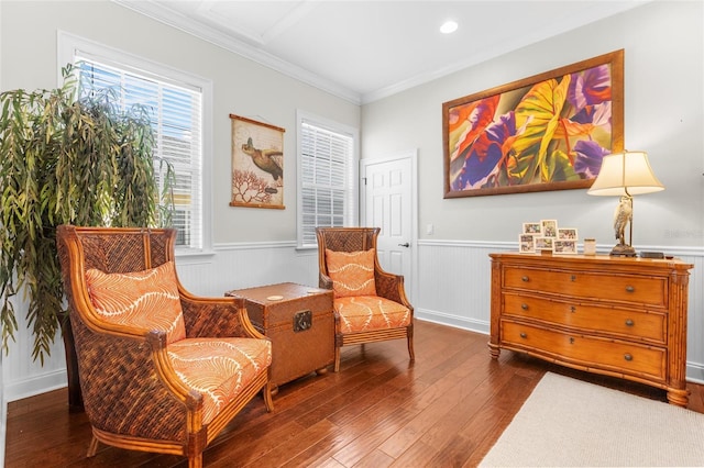 sitting room with dark hardwood / wood-style floors and crown molding