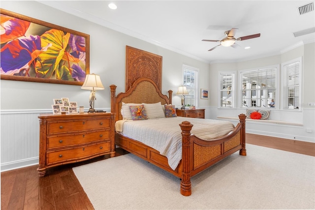 bedroom with ceiling fan, wood-type flooring, and ornamental molding