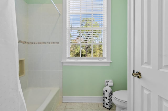 bathroom with tile patterned floors, toilet, and shower / bathtub combination with curtain