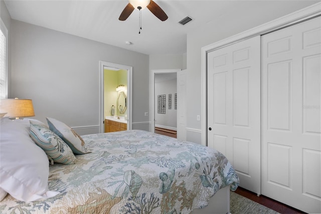 bedroom featuring connected bathroom, a closet, ceiling fan, and dark hardwood / wood-style floors