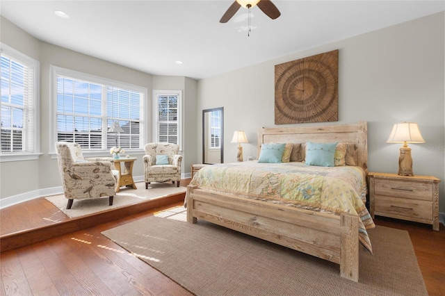 bedroom featuring multiple windows, wood-type flooring, and ceiling fan