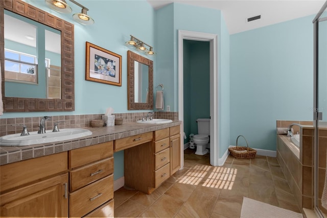 bathroom with vanity, backsplash, tile patterned flooring, toilet, and tiled tub