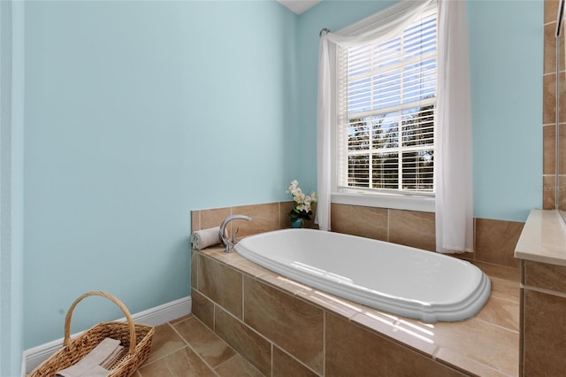 bathroom featuring tile patterned flooring and tiled bath