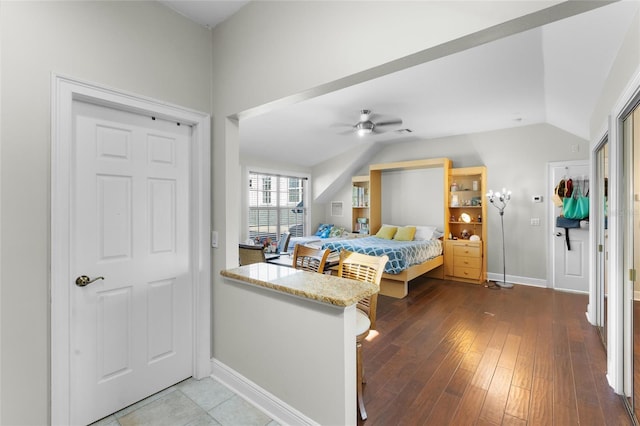 bedroom featuring ceiling fan, wood-type flooring, and lofted ceiling