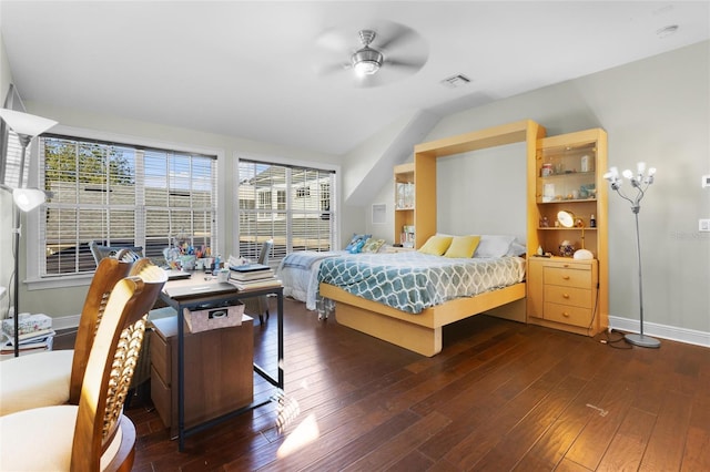 bedroom with ceiling fan, lofted ceiling, and dark wood-type flooring