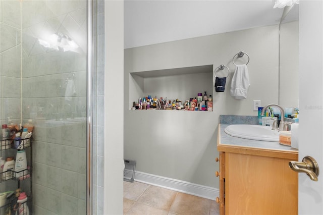 bathroom featuring tile patterned floors, vanity, and a shower with shower door