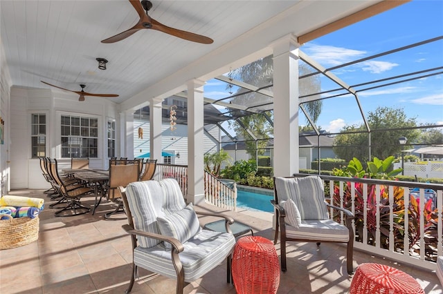 sunroom featuring plenty of natural light and ceiling fan