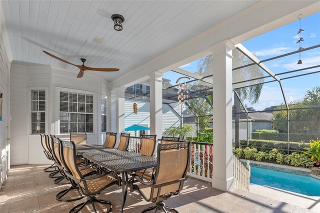 sunroom featuring a pool and ceiling fan