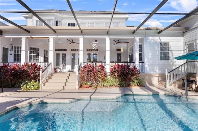 rear view of property featuring glass enclosure and ceiling fan