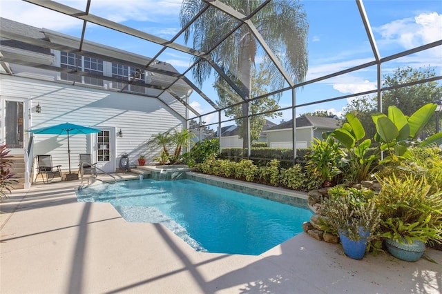 view of swimming pool with glass enclosure and a patio area