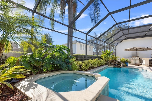 view of swimming pool with glass enclosure and area for grilling