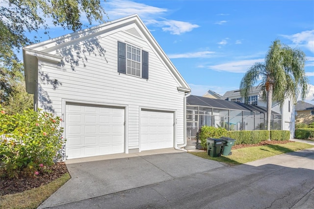 view of front of property featuring a garage and a lanai