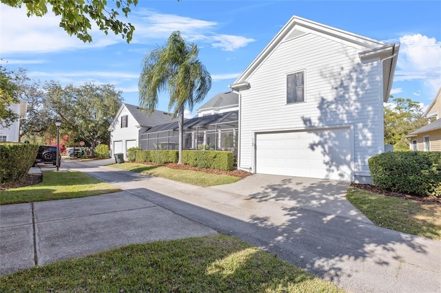 view of property exterior featuring a garage, a lanai, and a yard