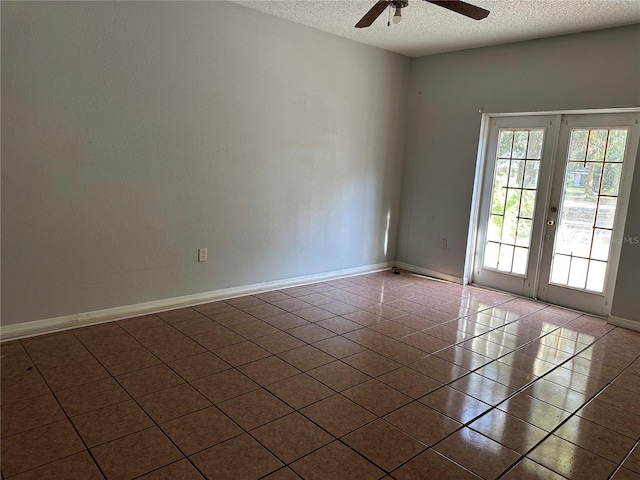 spare room featuring tile patterned flooring, ceiling fan, a textured ceiling, and french doors