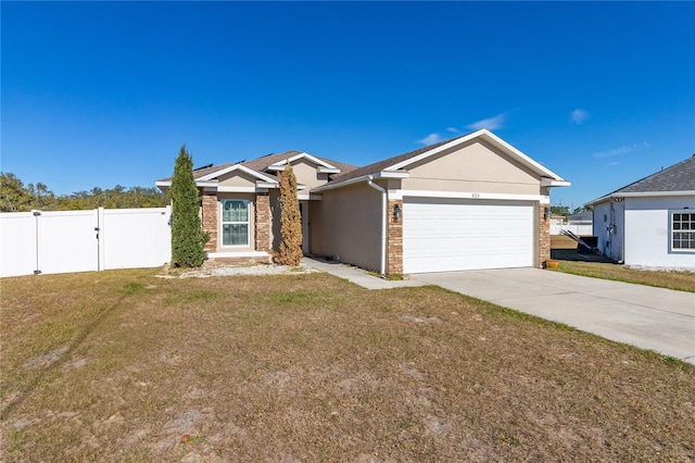 825 Desmoines Pl, Kissimmee, FL 34759 - single story home featuring an attached garage, concrete driveway, a gate, and stucco siding