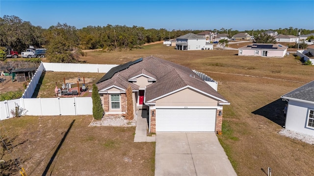 825 Desmoines Pl, Kissimmee, FL 34759 - view of front of property featuring a garage, concrete driveway, and brick siding