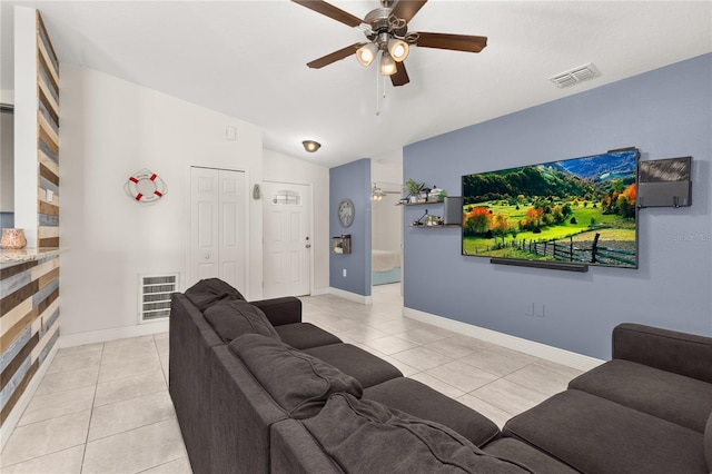 living room featuring ceiling fan, light tile patterned floors, and vaulted ceiling