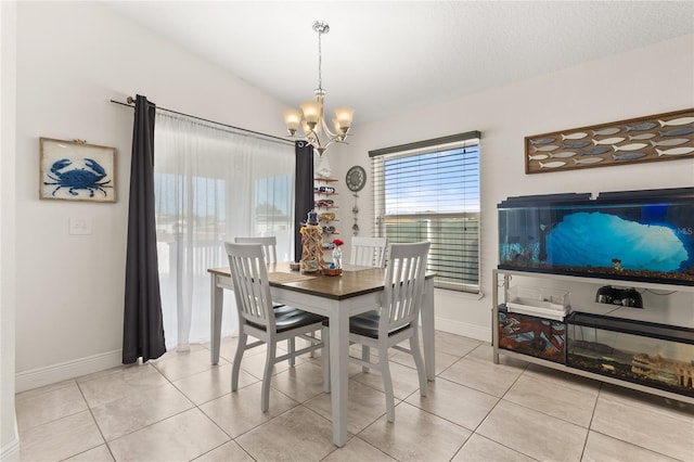 tiled dining area featuring an inviting chandelier