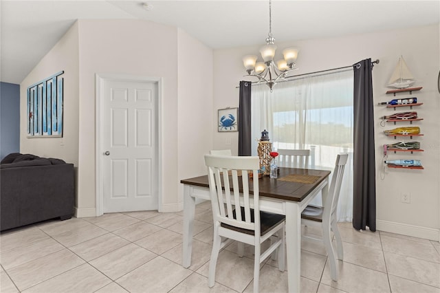 dining space featuring a chandelier, light tile patterned flooring, and vaulted ceiling