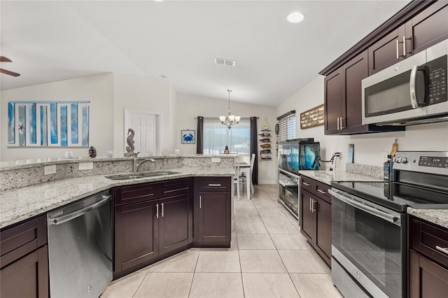 kitchen featuring pendant lighting, sink, stainless steel appliances, and vaulted ceiling