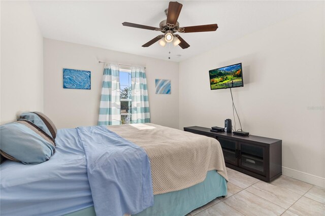 bedroom featuring ceiling fan and light tile patterned flooring