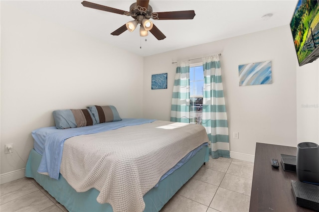 tiled bedroom featuring ceiling fan