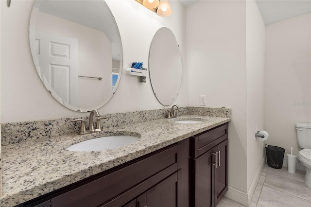 bathroom featuring tile patterned flooring, vanity, and toilet