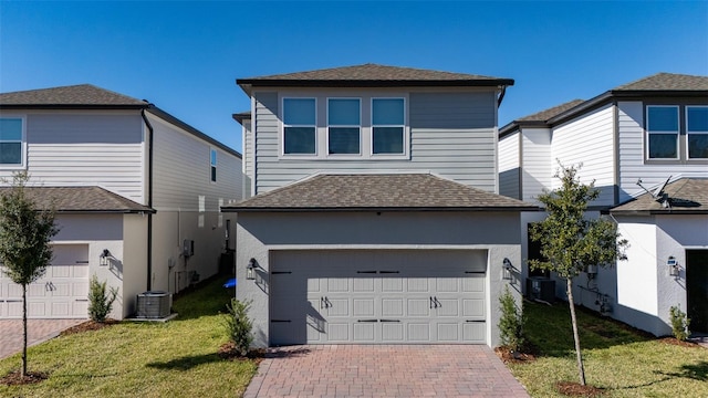 front facade with cooling unit, a garage, and a front yard