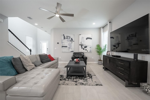 living room with ceiling fan and light tile patterned floors