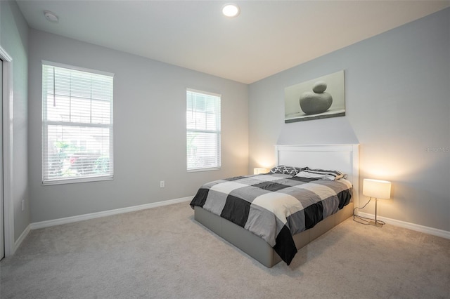 carpeted bedroom with multiple windows